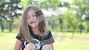 Little girl with messy hair, in the park , laughing; positive emotions