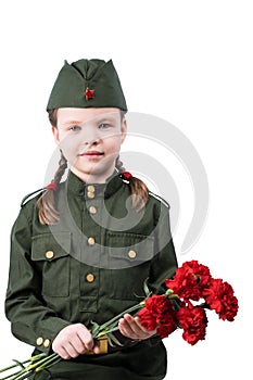 Little girl in military uniform holds a bouquet of red flowers, isolated on white