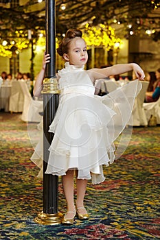 Little girl-model performs white gown