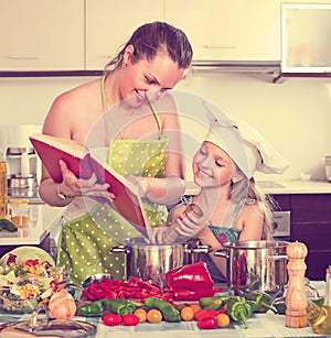 Little girl and mom with cookery book