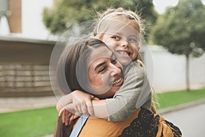 Little girl in Moms hug.