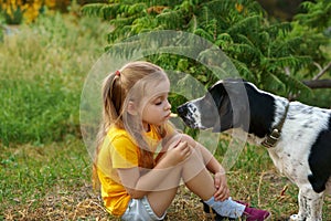 Little girl and mongrel dog outdoors