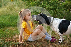 Little girl and mongrel dog outdoors