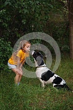 Little girl and mongrel dog outdoors
