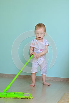 Little girl mopping the floor