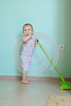 Little girl mopping the floor