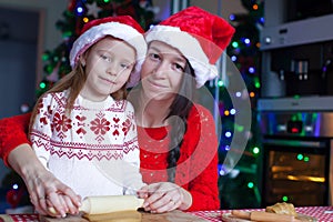 Little girl and mother baking Christmas