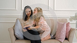 Little Girl with Mother Disputing Over Tablet PC