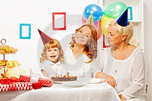 Little girl with mother and granny on birthday