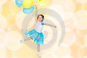 Little girl with multicolored balloons.