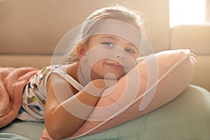 Little girl napping on couch.