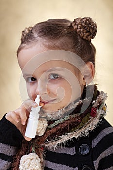 Little girl with nasal spray - fighting the flu