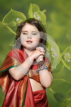 A little girl is in the national Indian dress