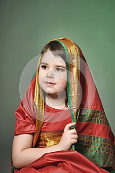 A little girl is in the national Indian dress