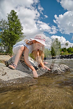 little girl in the natural landscape of a mountain river