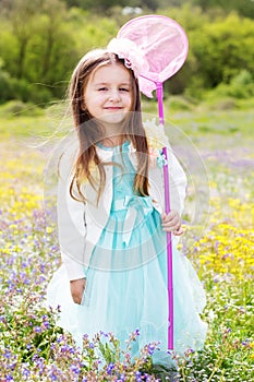 Little girl on the nature with butterfly net