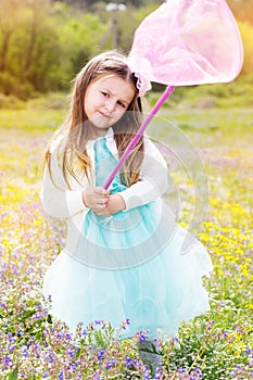 Little girl on the nature with butterfly net