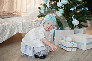 Little girl near Christmas tree with presents rejoices holiday, new year, decorations, gift, box, holiday, lifestyle