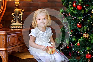 Little girl near festive christmas tree