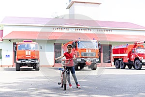 little girl near fire trucks