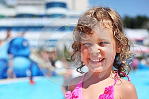 Little girl near pool in aquapark