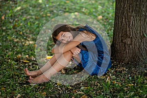 Little girl near a tree