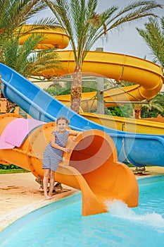 Little girl near water park slides