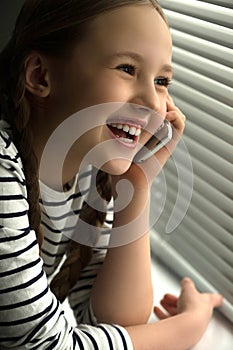 Little girl near window
