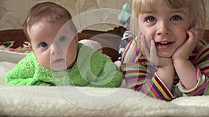 Little Girl and Newborn Baby, Two Sisters, Watching TV. 4K UltraHD, UHD