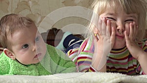 Little Girl and Newborn Baby, Two Sisters, Watching TV. 4K UltraHD, UHD