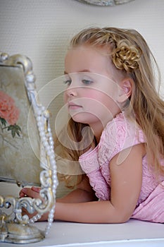 The little girl next to a mirror