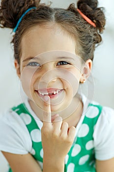 Little girl with no tooth. The child lost a tooth.