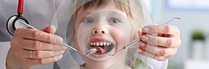 Little girl is not afraid to show teeth to dentist
