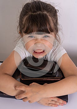 Little girl obsessed with phones mobile apps ignoring parents and toys at home, kid using smartphones checking social networks onl