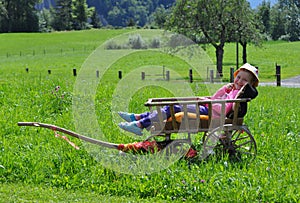 Little girl in old cart