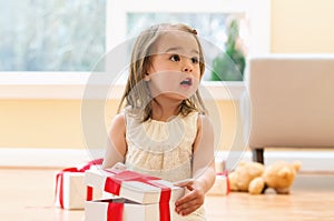 Little girl opening a Christmas present