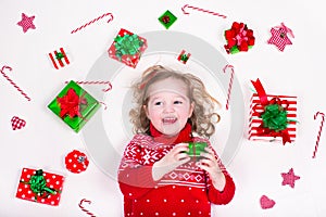 Little girl opening Christmas presents