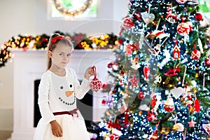 Little girl opening Christmas presents at fire place