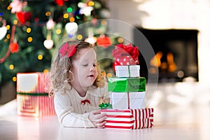 Little girl opening presents on Christmas morning