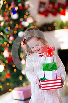 Little girl opening presents on Christmas morning