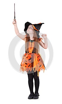 Little girl in orange costume of witch for Halloween photo