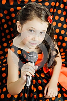 Little girl in orange peas dress