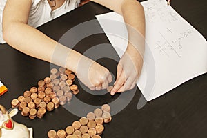 A little girl organizing her saved capital