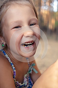 Little girl with orthodontics appliance and wobbly tooth