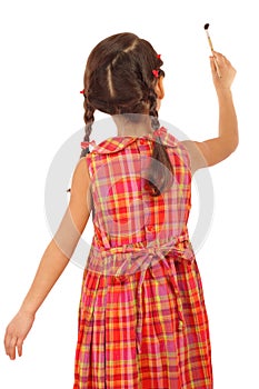 Little girl with a paintbrush, rear view