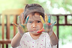 Little girl with painted hands