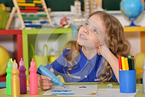 Little girl painting with felt pen