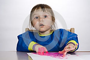 Little girl painting finger paint