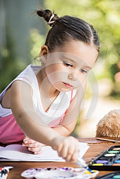 Little girl painting outdoor