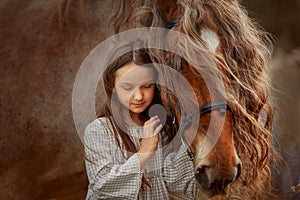 Little girl with palomino miniature horse in summer day